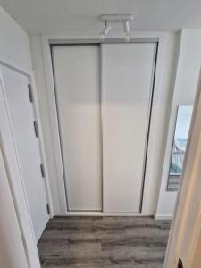 two white doors in a room with wood floors at Sea View La Cala 506 in Mijas Costa +3 photos