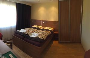 Postel nebo postele na pokoji v ubytování Penzion Toscana