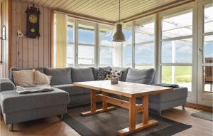 a living room with a couch and a table at Holiday Home Lemvig 12 in Lemvig