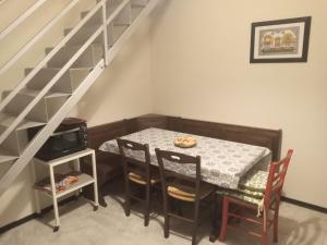 a dining room with a table and a staircase at Il Poggetto Moon Light Home Stay in Arezzo +25 photos