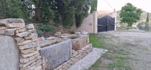 a stone retaining wall in a yard with a gate at Spacious Villa with Pool in Pruna, 140 m² in Pruna +25 photos