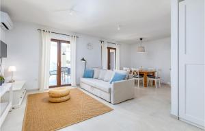 a living room with a couch and a table at Beautiful Home In Betiga With Wifi in Barbariga