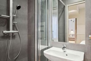 a bathroom with a sink and a shower at Hôtel Clémence in Paris