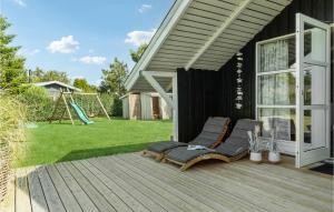 a deck with two chairs and a playground at Three-Bedroom Holiday Home In Sydals in Skovbyballe +10 photos