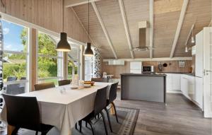 a kitchen and dining room with a table and chairs at Three-Bedroom Holiday Home In Sydals in Skovbyballe