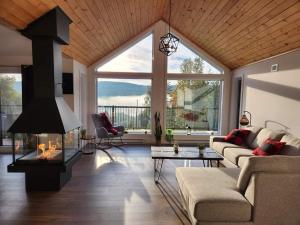 a living room with a couch and a fireplace at Chalet Isatis - SPA - Access to the Lake in Saint Come