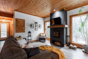 a living room with a couch and a fireplace at Zazz - For precious moments with family or friends in Chertsey