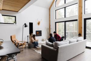 a group of people sitting in a living room at Nomade A unique experience in the heart of nature in Grande Vallee