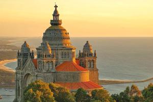a large building with a tower on top of the ocean at CasAmalia 54 in Viana do Castelo