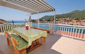 a table on a balcony with a view of the water at 4 Bedroom Beautiful Apartment In Brna in Brna