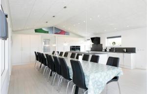 a dining room with a table and chairs at Awesome Home In Jerup With Kitchen in Bratten Strand