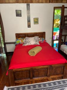 a bedroom with a red bed with a red blanket at Papaya Wildlife Lodge in Cahuita +108 photos