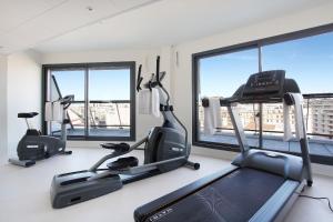a gym with two exercise bikes and two windows at Appart'hôtel Odalys City - Marseille Centre Parc Chanot Vélodrome in Marseille