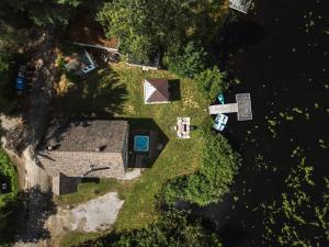 an overhead view of a house in the trees at Le Lac Apaisant - Rustic Haven by the Water in Saint-Calixte