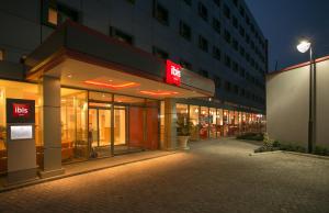 an empty street in front of a building at night at Ibis Lagos Ikeja in Ikeja