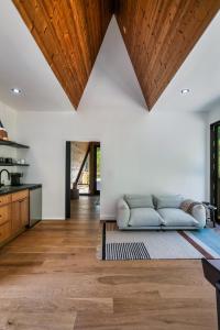 a living room with a couch and wooden ceilings at An Escape to the Forest, A Smoky Mountain A-Frame Cabin, Couple's Romantic Get-away! in Sevierville