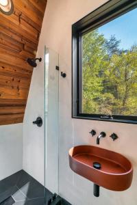 a bathroom with a sink and a window at An Escape to the Forest, A Smoky Mountain A-Frame Cabin, Couple's Romantic Get-away! in Sevierville