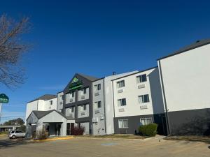 a large white building with a sign on it at Wingate by Wyndham Sioux City in Sioux City