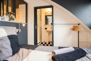 リールにあるLittle Suite - Marius et Romainのベッドルーム1室(ベッド1台付)、屋根裏部屋1室