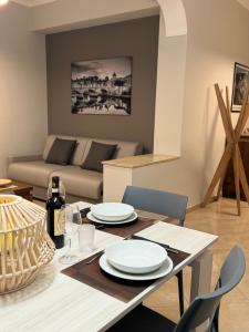 a living room with a table and a couch at Casa Acilia Luxury Apartment in Acilia