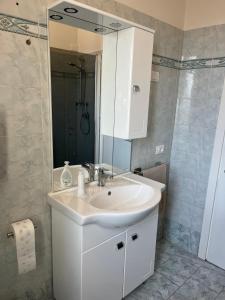 a bathroom with a white sink and a mirror at Casa Dante in Terranuova Bracciolini