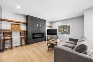 a living room with a couch and a tv at Flora's House in Calgary