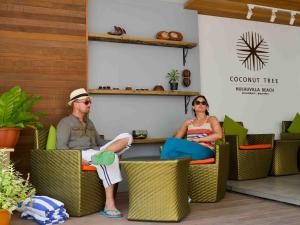 a man and a woman sitting in chairs at Coconut Tree Hulhuvilla Beach in Hulhumale