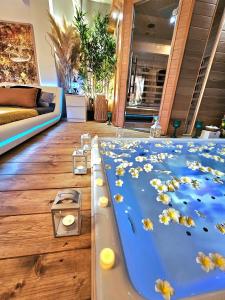 a bath tub with flowers on it in a room at AMA Esclusive SPA Bologna in Bologna +29 photos
