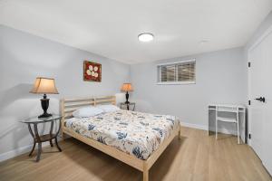 a bedroom with a bed and a table and a window at Flora's House in Calgary