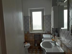 a bathroom with a sink and a toilet and a window at domum solis in Marina di Cerveteri +9 photos