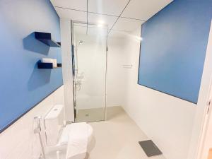 a bathroom with a glass shower and a toilet at Luxury 2 Bedroom in the Nook 1 next to Metro Energy in Dubai