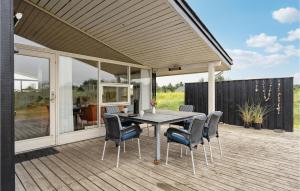 a patio with a table and chairs on a deck at Holiday Home Ringkobing Xliii in Klegod