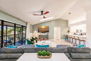 a living room with a couch and a table at Casa Marco - Heated Pool, Game Room, Mini Golf in Marco Island