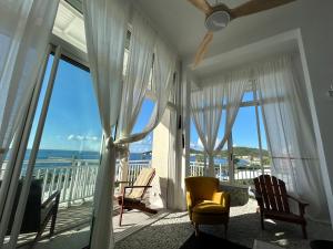 a living room with a view of the ocean at Les Paletuviers in Marigot