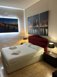 a bedroom with a bed with paintings on the wall at Palazzo Duomo in Verona