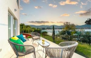 a patio with chairs and a table and a view of the water at Villa Tala in Mrljane +34 photos