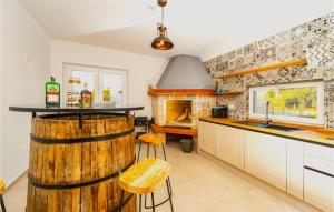 a kitchen with a wooden barrel in the middle of it at Villa Tala in Mrljane