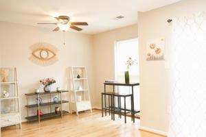 a living room with a ceiling fan and a window at Charming 3bd Alexandria House, 11 miles to DC, Nice front view in Alexandria