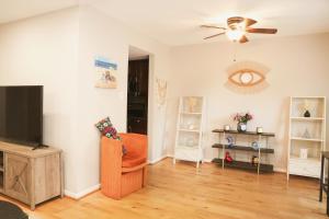 a living room with a flat screen tv and a chair at Charming 3bd Alexandria House, 11 miles to DC, Nice front view in Alexandria