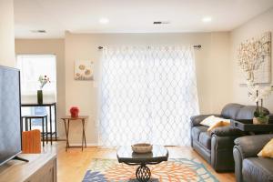 a living room with a couch and a table at Charming 3bd Alexandria House, 11 miles to DC, Nice front view in Alexandria
