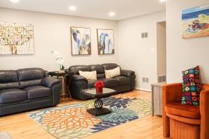 a living room with a couch and a table at Charming 3bd Alexandria House, 11 miles to DC, Nice front view in Alexandria