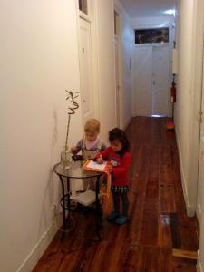 two children sitting at a table in a room at Nations Rooms in Lisbon