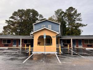 杰克逊维尔Budget Inn Jacksonville的建筑物前的空停车场