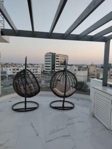three chairs sitting on top of a balcony at Luxury Apartment in Larnaca 2 Bedroom 1 Balcony in Larnaka