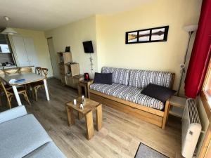 a living room with a couch and a table at Résidence Le Sextant - maeva Home - 2 pièces 6 personnes Confort MAE-9594 in Les Coches +16 photos