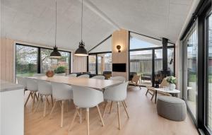 a kitchen and dining room with a table and chairs at Nice Home In Ebeltoft With Sauna in Ebeltoft