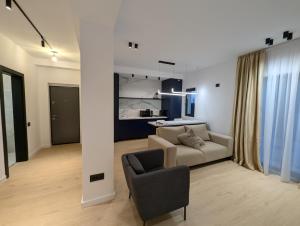 a living room with a couch and a chair at Zenith DM Otopeni Airport & Therme in Otopeni