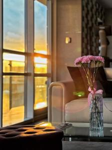 a vase with flowers on a table in a living room at Black Pearl - Amazing City View, 130 sqm in Warsaw