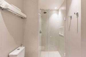 a bathroom with a shower and a toilet at TW Cyclinn Vila Olimpia in São Paulo