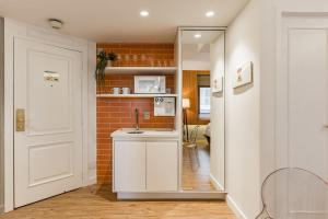 a kitchen with a white door and a brick wall at TW Cyclinn Vila Olimpia in São Paulo